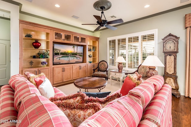 living room with a ceiling fan, recessed lighting, wood finished floors, and ornamental molding