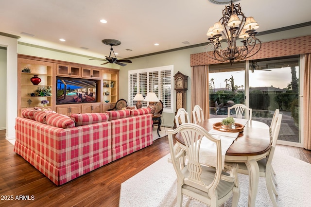 dining area featuring ceiling fan with notable chandelier, recessed lighting, dark wood-style floors, and ornamental molding