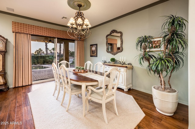 dining area featuring visible vents, a notable chandelier, ornamental molding, dark wood finished floors, and baseboards