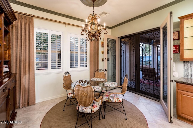 dining space featuring a notable chandelier, visible vents, baseboards, and ornamental molding