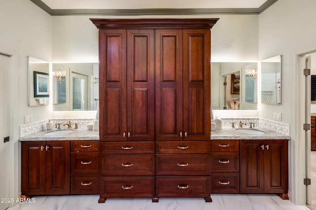 bathroom featuring double vanity, ornamental molding, and a sink