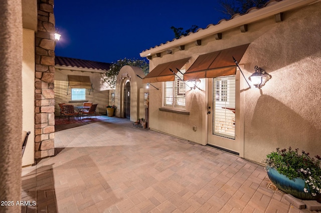 patio at twilight featuring outdoor dining area