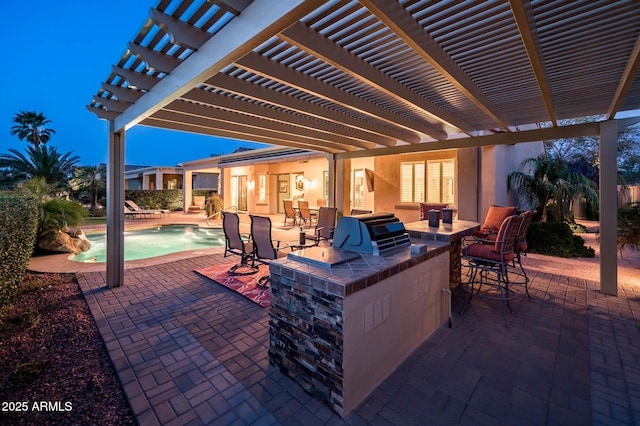 view of patio featuring exterior kitchen, a pergola, and outdoor dry bar