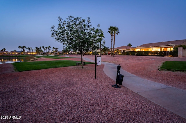 view of home's community with a yard and a water view