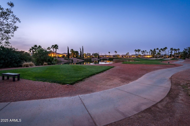 view of community with a yard and a water view