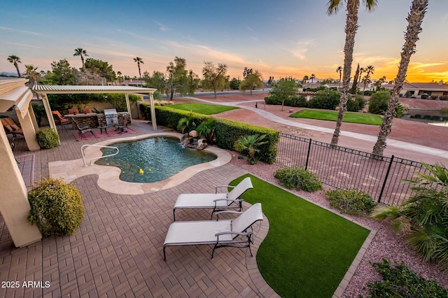 pool at dusk featuring a patio area, a lawn, a fenced backyard, and a fenced in pool