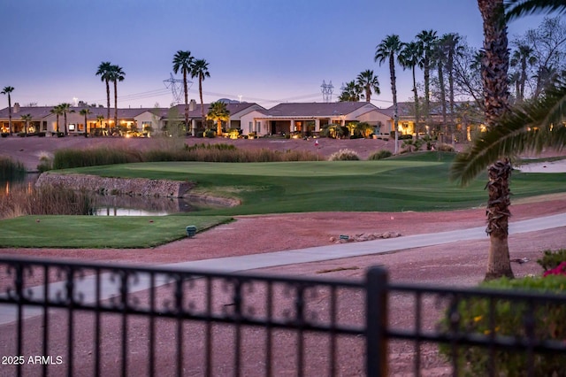 surrounding community with a lawn and fence