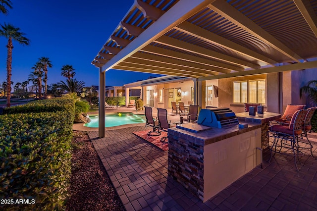 view of patio featuring exterior kitchen, an outdoor pool, and a pergola