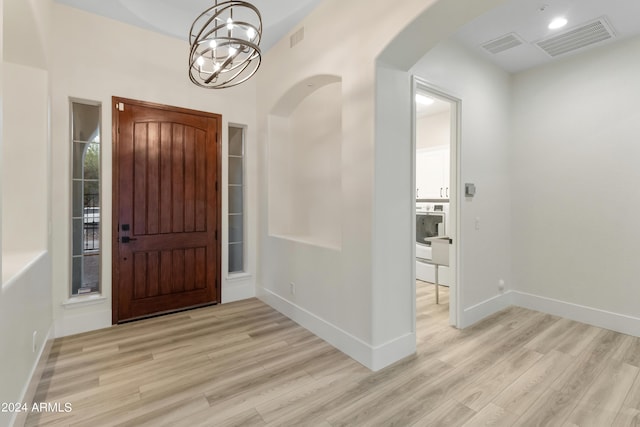 foyer featuring light hardwood / wood-style floors and a chandelier