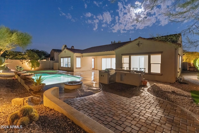 back house at dusk featuring area for grilling, a fenced in pool, and a patio