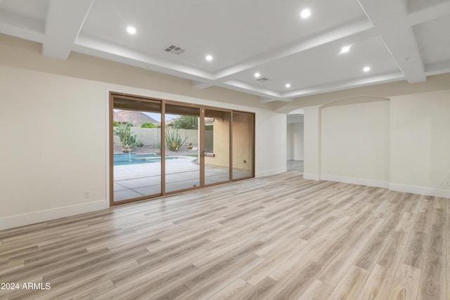 interior space with light hardwood / wood-style flooring, coffered ceiling, and beamed ceiling