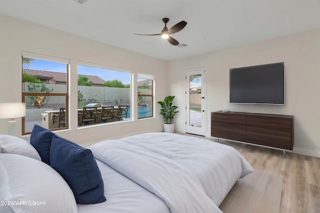 bedroom with multiple windows, ceiling fan, access to outside, and light wood-type flooring