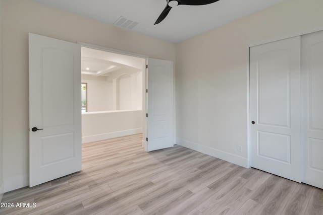 unfurnished bedroom featuring a closet, ceiling fan, and light hardwood / wood-style floors