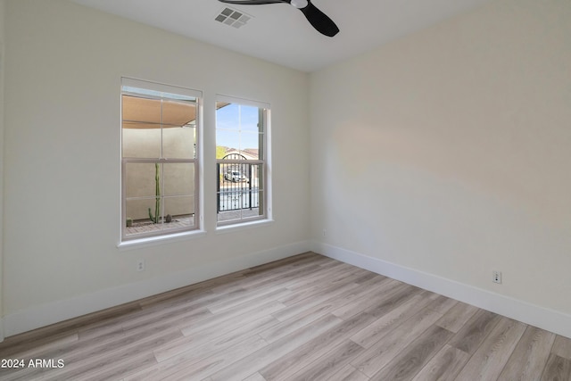 empty room with ceiling fan and light hardwood / wood-style flooring