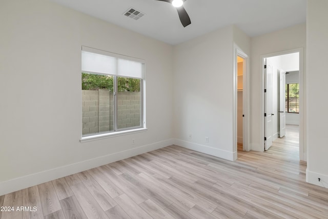 empty room featuring ceiling fan and light hardwood / wood-style floors