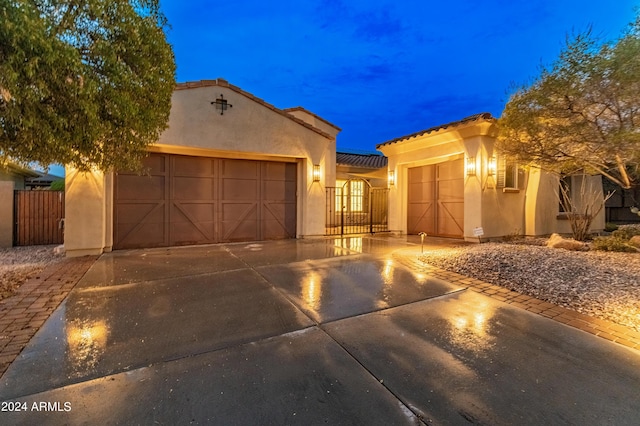 mediterranean / spanish-style home with a garage