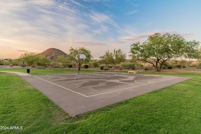 view of sport court with a yard and a mountain view