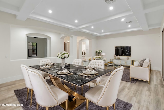 dining space with light hardwood / wood-style floors, coffered ceiling, and beamed ceiling