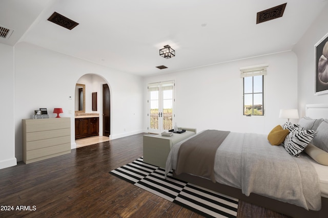 bedroom with hardwood / wood-style flooring and ensuite bath