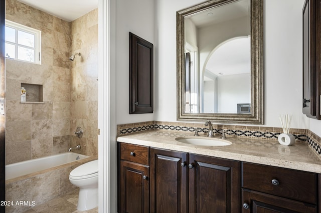 full bathroom with decorative backsplash, toilet, vanity, and tiled shower / bath