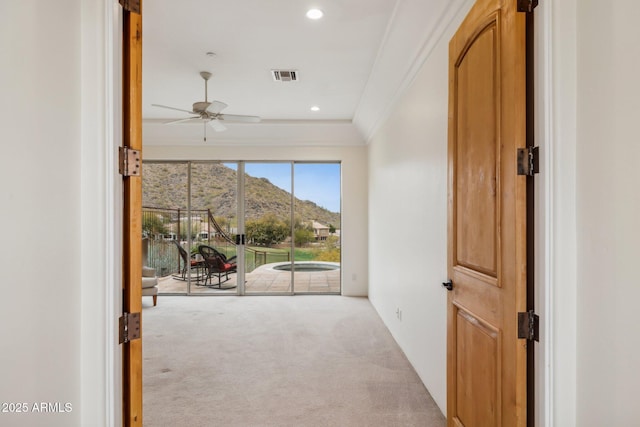 interior space with crown molding, a mountain view, and carpet floors