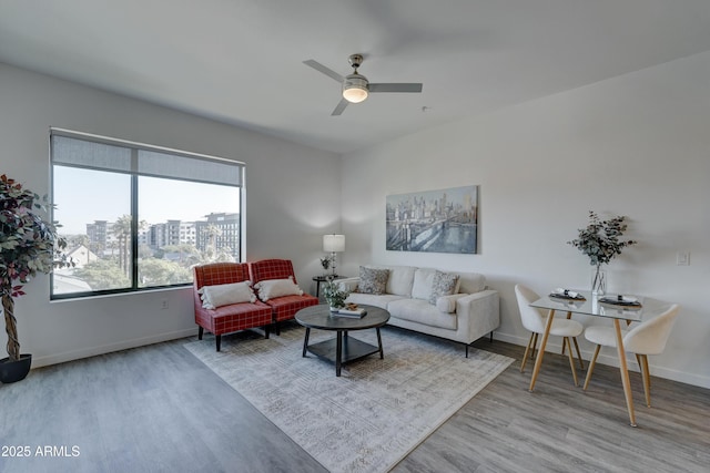 living room with light hardwood / wood-style flooring and ceiling fan