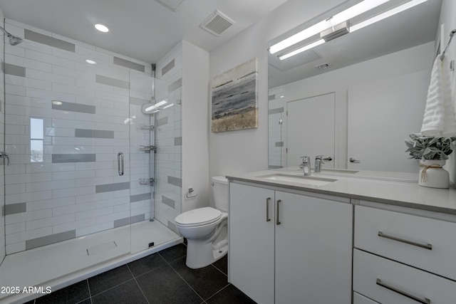 bathroom featuring vanity, tile patterned floors, toilet, and walk in shower