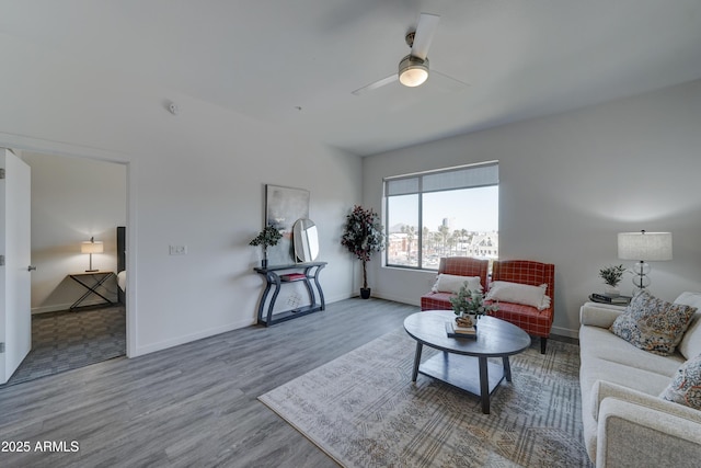 living room featuring hardwood / wood-style flooring and ceiling fan