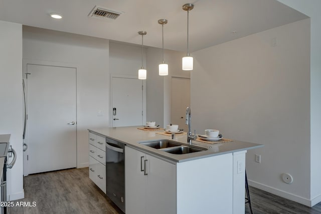 kitchen featuring sink, dishwasher, white cabinetry, hanging light fixtures, and a center island with sink