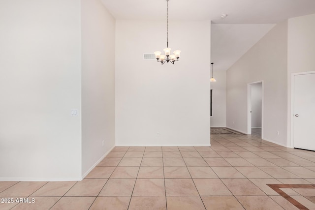 unfurnished room featuring a chandelier, light tile patterned flooring, high vaulted ceiling, and baseboards