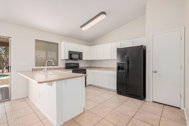 kitchen featuring a peninsula, a sink, white cabinetry, light countertops, and black appliances