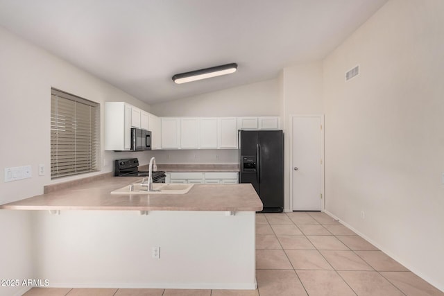 kitchen featuring visible vents, a peninsula, light countertops, black appliances, and a sink