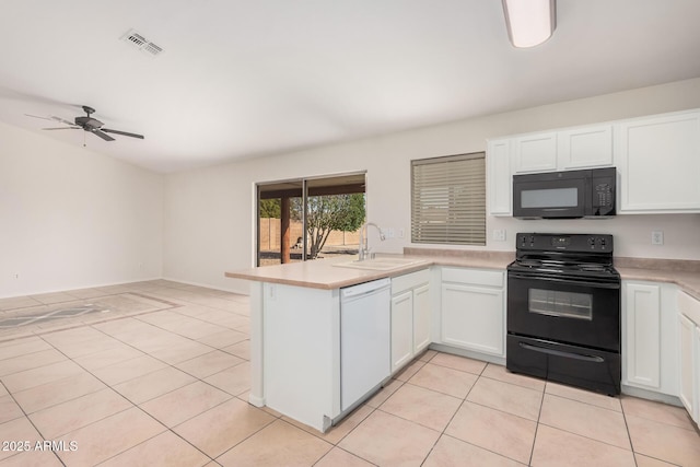 kitchen with light tile patterned floors, visible vents, a peninsula, black appliances, and a sink