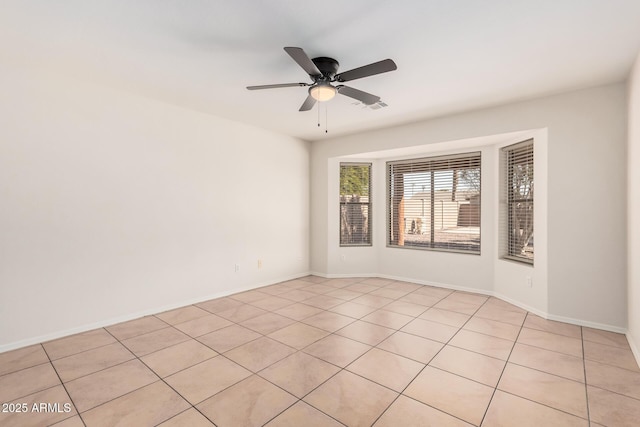 unfurnished room with a ceiling fan, visible vents, and baseboards