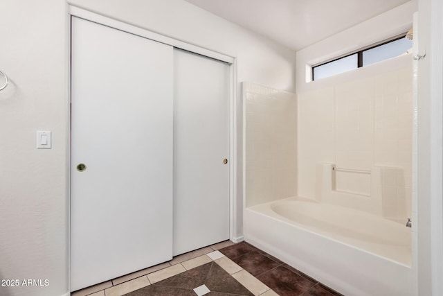 full bath featuring tile patterned flooring and shower / tub combination