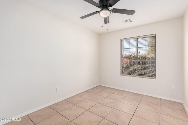 spare room featuring baseboards, visible vents, ceiling fan, and light tile patterned flooring