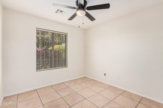 spare room with visible vents, ceiling fan, baseboards, and light tile patterned floors