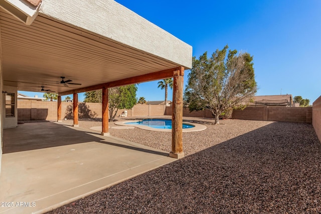 view of patio / terrace with a fenced backyard, a fenced in pool, and a ceiling fan