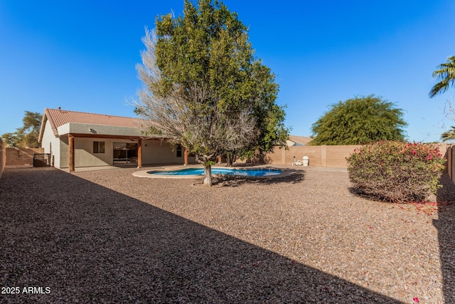 view of yard featuring a patio area, a fenced backyard, and a fenced in pool