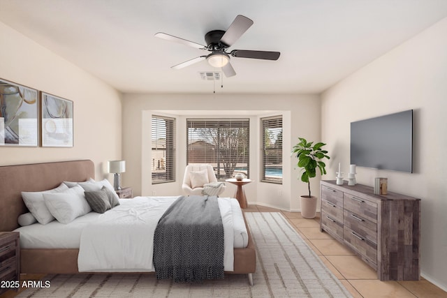 bedroom with light tile patterned floors, ceiling fan, visible vents, and baseboards