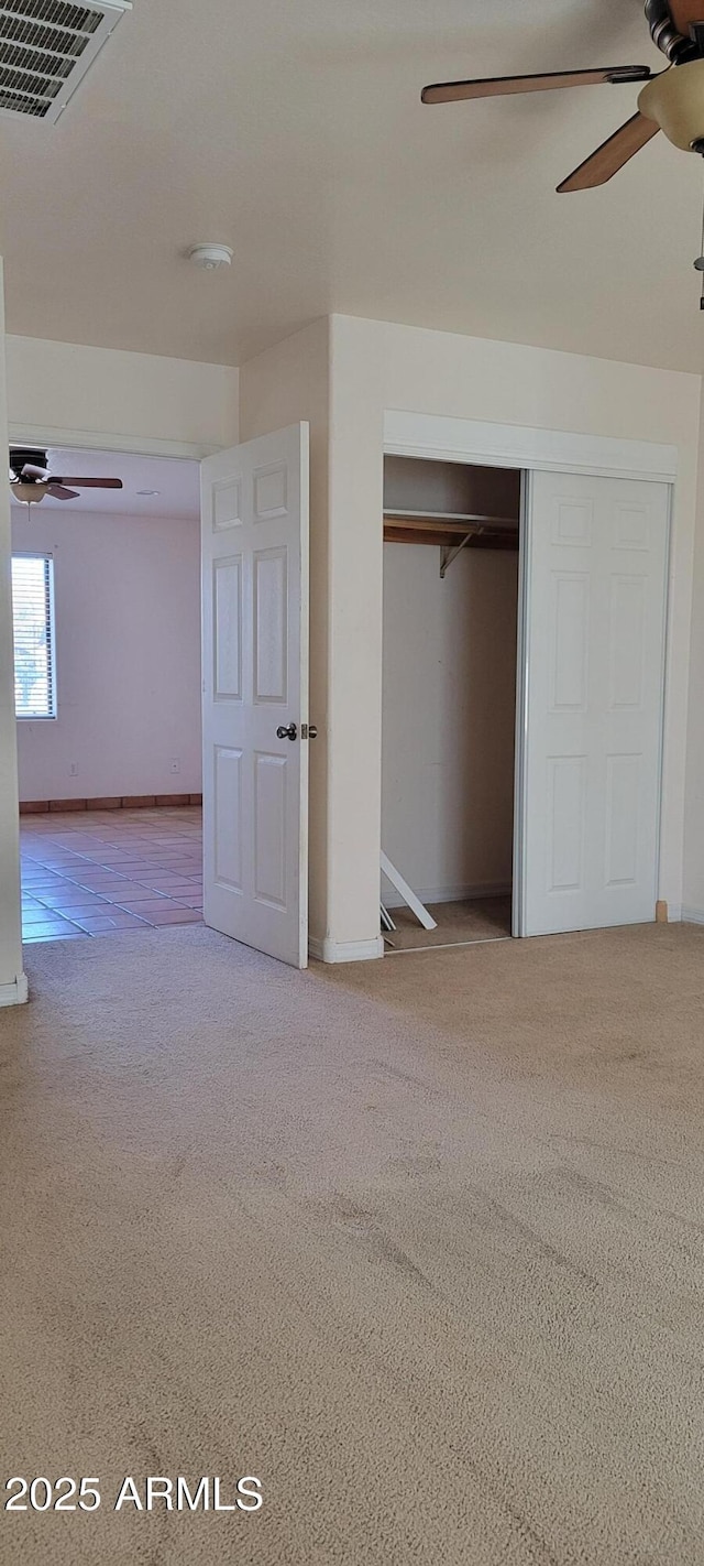 321 S Bridge St, Superior, AZ 85173 - unfurnished bedroom with ceiling fan, a closet, and light colored carpet
