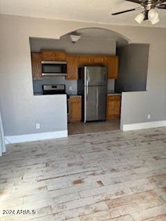 kitchen featuring ceiling fan, light wood-type flooring, and appliances with stainless steel finishes