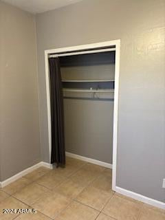 interior space with light tile patterned flooring and a closet