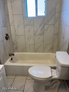 full bathroom featuring toilet, tiled shower / bath combo, and vanity