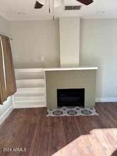 unfurnished living room with ceiling fan and dark hardwood / wood-style flooring