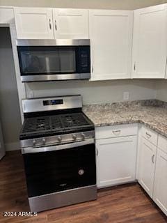 kitchen featuring dark hardwood / wood-style flooring, white cabinets, and stainless steel appliances