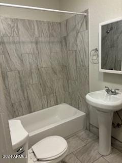 bathroom featuring toilet and shower / tub combination