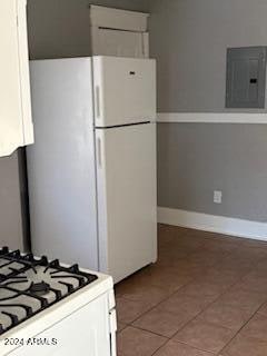 kitchen with white cabinetry, electric panel, tile patterned floors, and white appliances