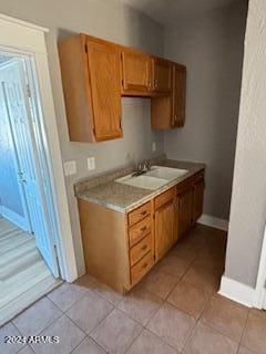 kitchen featuring sink and light tile patterned flooring