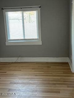 spare room with hardwood / wood-style floors